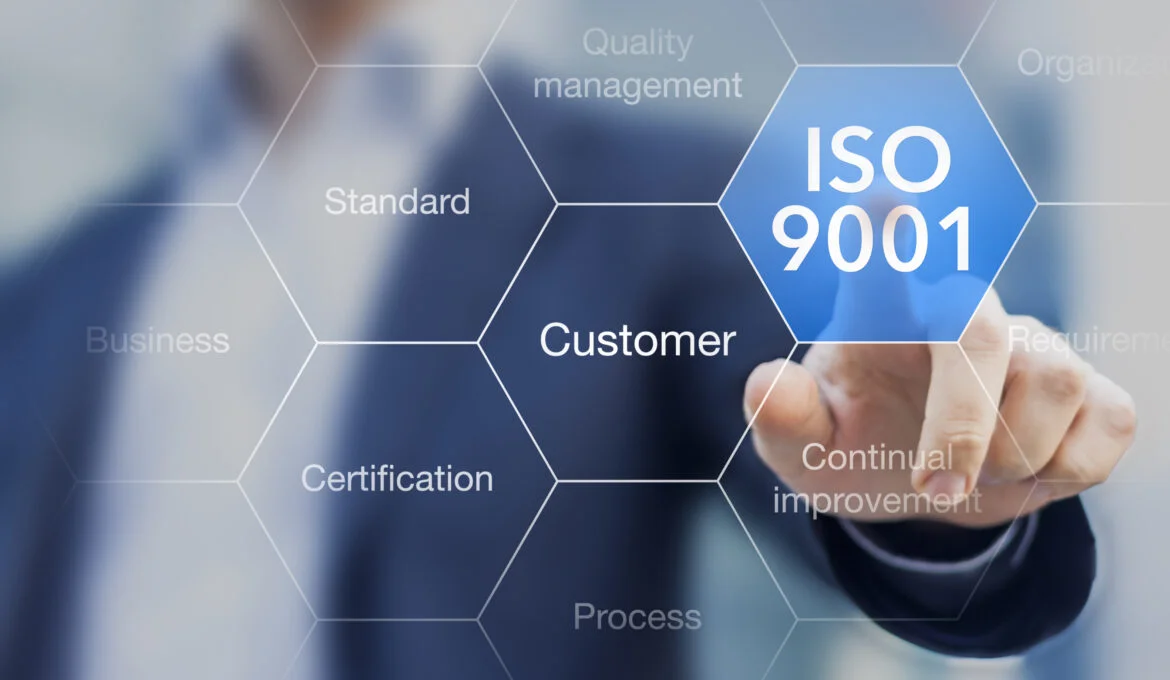 Person tapping the words ISO 9001 certification for quality